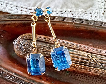 Beautiful art deco style drop earrings with cobalt blue faux sapphires, octagon cut glass rhinestone dangling from gold tone tube bead posts