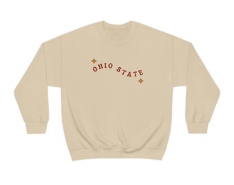 May include: A beige sweatshirt with the text "OHIO STATE" in red lettering and two small gold stars.
