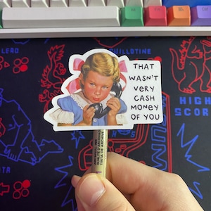 May include: A sticker featuring a vintage illustration of a young girl on the phone with the text "That wasn't very cash money of you".