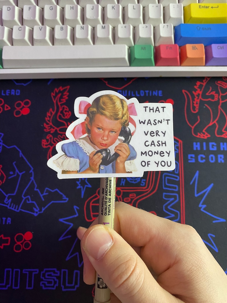 May include: A sticker featuring a vintage illustration of a young girl on the phone with the text "That wasn't very cash money of you".