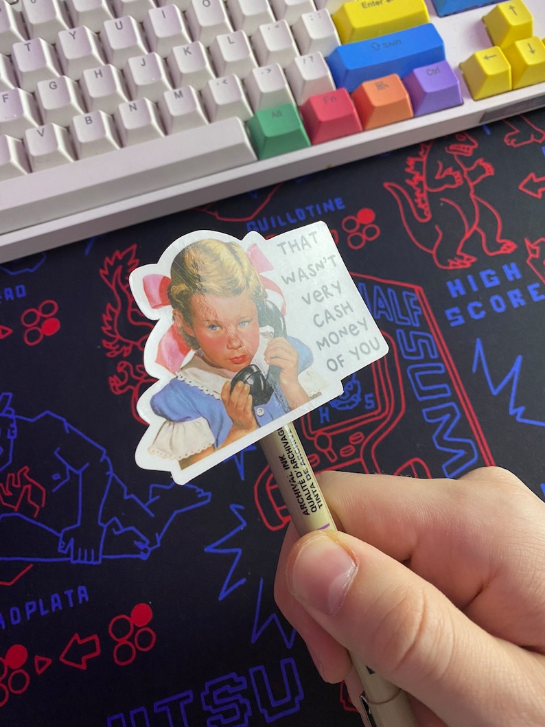 May include: A sticker featuring a girl on the phone with the text "That wasn't very cash money of you".