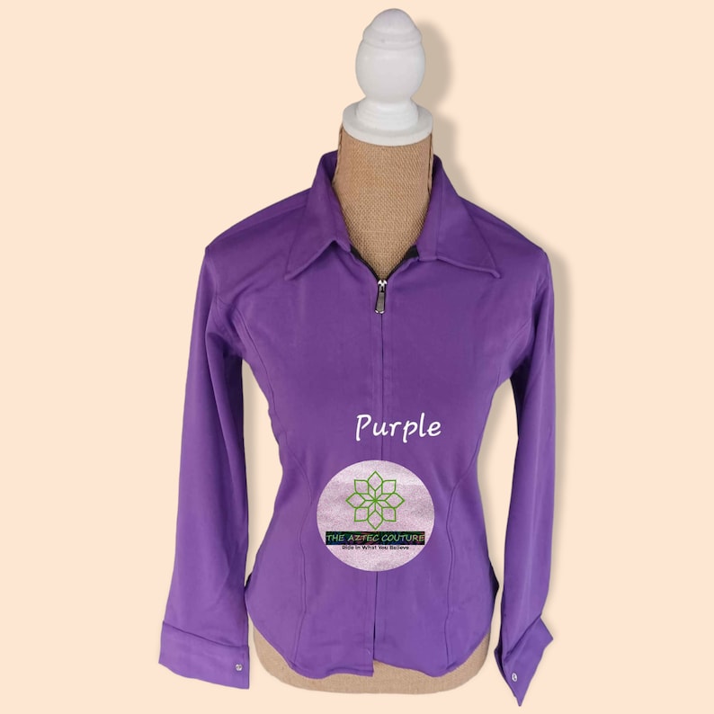 May include: Purple long-sleeve zip-up shirt with a collar. The shirt is on a white mannequin. The text "Purple" is printed on the shirt. The text "The Aesthetic Couture" is printed on a circle with a flower design.