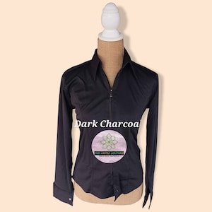 May include: A dark charcoal long-sleeve button-up shirt with a zipper closure. The shirt has a fitted silhouette and a small logo on the front that says "The Aesthetic Couture".