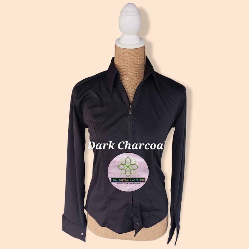 May include: A dark charcoal long-sleeve button-up shirt with a zipper closure. The shirt has a fitted silhouette and a small logo on the front that says "The Aesthetic Couture".