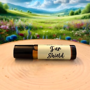 May include: A brown glass roller bottle with a yellow label that says "Fur Shield" on a wooden surface. The bottle is filled with a clear liquid.