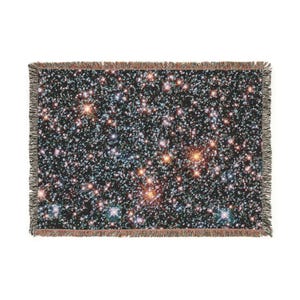 May include: A rectangular throw blanket featuring a detailed image of a star cluster against a black background. The blanket has a fringed edge and displays a multitude of stars in various colors, including white, orange, and blue.
