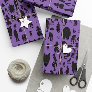 May include: Purple wrapping paper with a repeating pattern of black silhouettes of monsters with red eyes. The paper is wrapped around a gift box with a brown twine bow and a white heart-shaped tag.