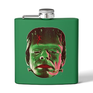 May include: Green flask with a vintage illustration of Frankenstein's monster. The monster's face is green with red and pink accents. The flask has a silver cap and hinge.