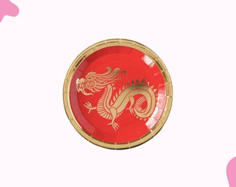 May include: Red paper plate with a gold dragon design. The plate has a gold rim and a red center. The dragon is a detailed illustration in gold. This plate is suitable for themed parties and events.