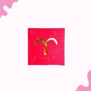 May include: A red square card with a gold Aries symbol and constellation details. The word "aries" is written in gold script at the bottom. The background has a subtle dotted pattern.