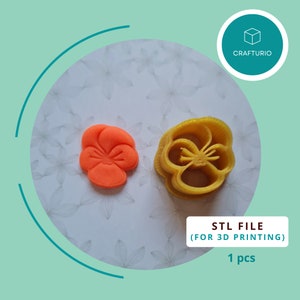 May include: A 3D printed STL file for a flower cookie cutter. The cookie cutter is yellow and shaped like a pansy flower. The image also shows a smaller orange pansy cookie cutter.