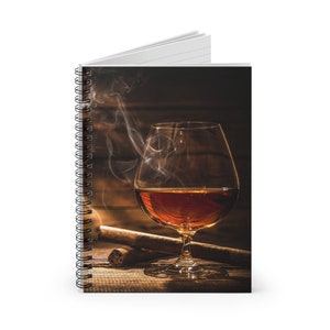 May include: A glass of amber-colored liquor sits on a wooden surface with a lit cigar. Smoke curls up from the cigar, creating a hazy atmosphere.