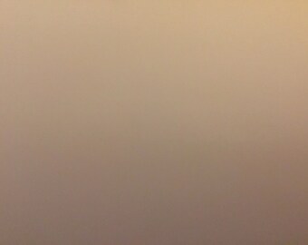May include: A plain, light brown background.