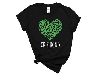 May include: Black t-shirt featuring a green heart made of ribbons and small hearts. The text "CP STRONG" is printed in white below the heart. The shirt is made of a soft material.