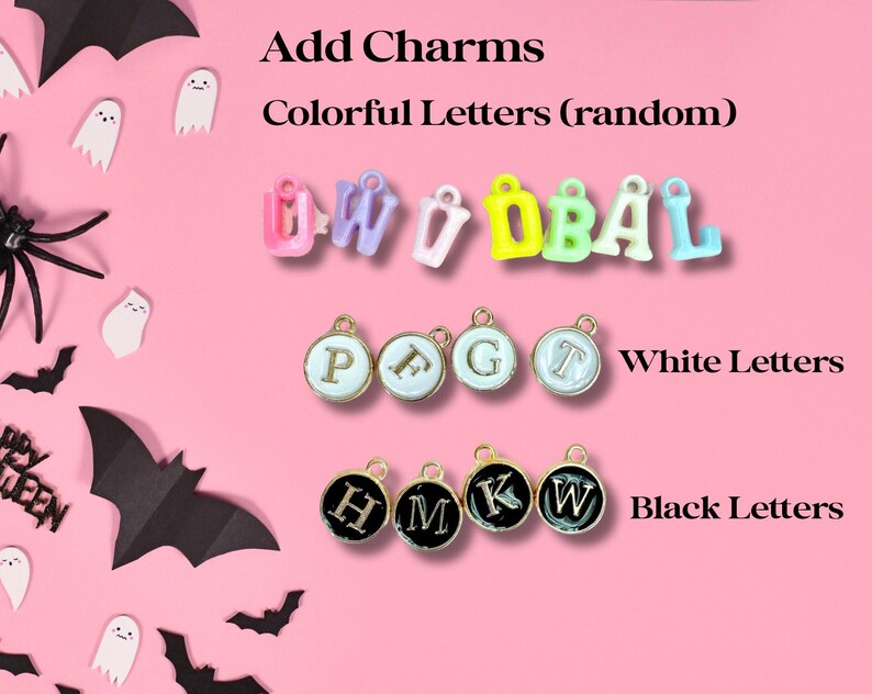 May include: Assortment of colorful letter charms for jewelry making. The charms are in various colors, including pink, blue, yellow, and green. There are also white and black letter charms.