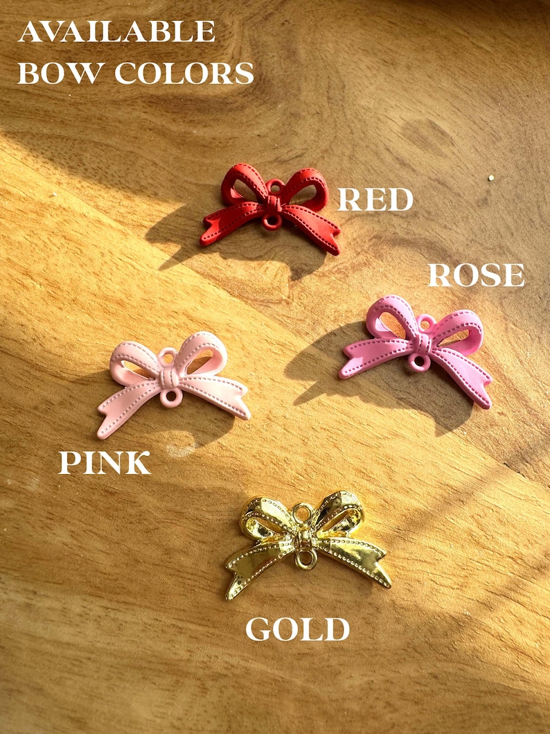 May include: Available bow colors: red, rose, pink, and gold. The bows are made of a shiny material and have a simple design.