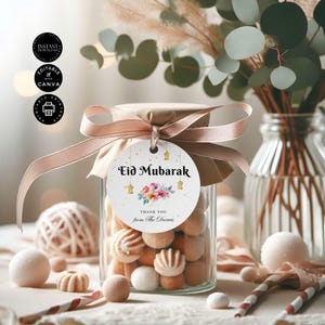 May include: A white round gift tag with gold glitter and a floral design. The tag says "Eid Mubarak" and "Thank you from The Darwis".