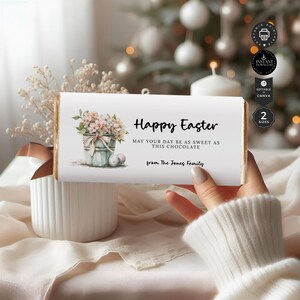 May include: Printable Easter chocolate bar wrapper with a watercolor illustration of a bucket of flowers and eggs. The text reads "Happy Easter, May your day be as sweet as this chocolate, from The Jones Family."