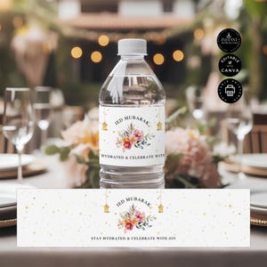 May include: Water bottle label with a gold and pink floral design. The label says "Eid Mubarak" and "Stay Hydrated & Celebrate with Joy".