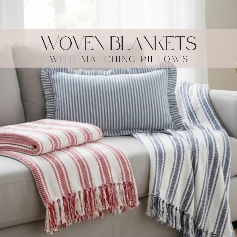 a cozy living space with a gray couch and a striped blanket draped over it. The blanket has a mix of red and white stripes, and there is a matching gray and white striped pillow on the couch. The text overlay reads "WOVEN BLANKETS WITH MATCHING PILLOWS".