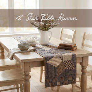 May include: A 72-inch Star Table Runner made of 100% cotton. The runner features a patchwork design with various patterns in shades of brown, beige, and navy blue. A white pitcher with flowers, bowls, and books are on the table.
