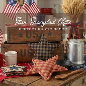 May include: Rustic wooden crates with "USA" stenciled on them, a star-shaped pillow, and American flags. The image also features a metal coffee pot, mugs, and a wooden spoon. Text reads "Star Spangled Gifts - Perfect Rustic Decor."