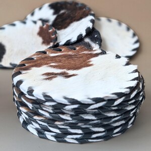 Drink Protection Mats Cowhide Leather Coasters Set Natural Hide Material Western Style Design Table Surface Guard Kitchen Counter Protection Handmade Quality Construction Genuine Leather Stitching Rustic Home Accessory Unique Pattern