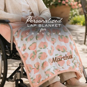 May include: A personalised lap blanket for Grandma, with a peach pattern on a white background. The blanket has a peach-coloured border and the name "Martha" in a brown script. The text "Personalized Lap Blanket for Grandma" is also visible.