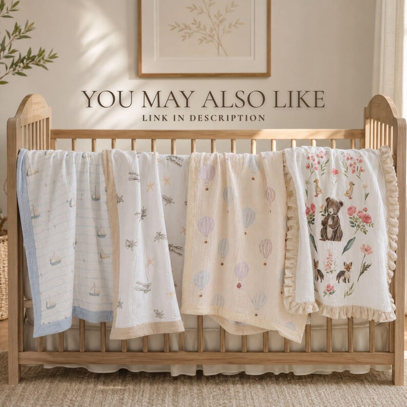 A wooden crib with a variety of colorful baby blankets and a framed picture on the wall above it.