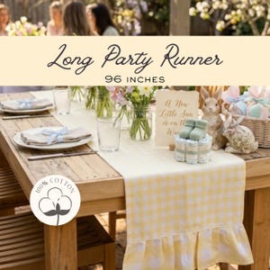 May include: A yellow and white gingham party runner, 96 inches long, with a ruffled edge, displayed on a wooden table set for a celebration. The table is decorated with flowers, plates, and a baby-themed centerpiece.