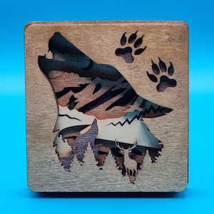 Howling Wolf Ornament. Free-standing laser cut and layered piece featuring a beautiful howling wolf and intricate internal designs.