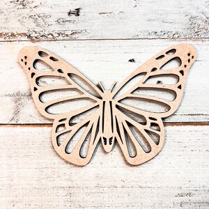 May include: A wooden butterfly cutout with intricate details, ideal for crafting and decorating.