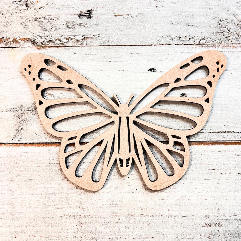 May include: A wooden butterfly cutout with intricate details, ideal for crafting and decorating.