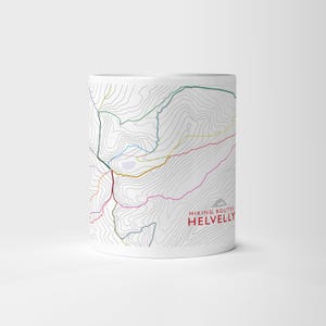 Puede incluir: Taza de cerámica blanca con un diseño de mapa topográfico detallado y rutas de senderismo coloridas. El texto "HIKING ROUTES HELVELLY" está impreso en rojo y gris. Perfecto para senderistas.