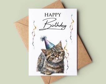 May include: A white card with the text "Happy Birthday" in black script. A watercolor illustration of a tabby cat wearing a colorful party hat is on the card. The cat is looking up with a surprised expression. Colorful confetti is scattered around the cat.