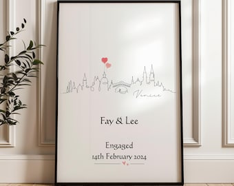 May include: Black framed print featuring a line drawing of a city skyline with two heart-shaped balloons. The print includes the names "Fay & Lee", the word "Engaged", and the date "14th February 2024".