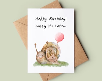 May include: A white card with the text "Happy Birthday! Sorry It's Late..." and a watercolor illustration of a snail carrying a pink balloon. The snail has a tag that says "Snail Mail".