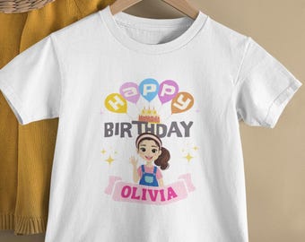 May include: White t-shirt with a colourful happy birthday graphic featuring a girl with a cake and balloons. The name Olivia is printed below the graphic.