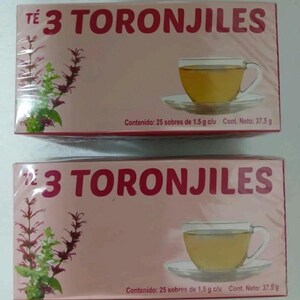 May include: Two boxes of "TÉ 3 TORONJILES" tea. The boxes are light pink with the text in red. Each box features an illustration of a teacup with tea and a sprig of a plant. The boxes contain 25 tea bags of 1.5 g each, with a net weight of 37.5 g.