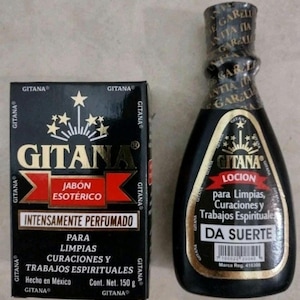 May include: A black rectangular box of Gitana Jabón Esotérico weighing 150 grams and a black bottle of Gitana Locion. Both items feature gold text, a red banner, and a starburst graphic. The bottle has a black cap with repeating Gitana text.