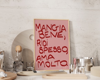 May include: A pink framed print with the Italian phrase "Mangia bene, ridi spesso, ama molto" written in red.