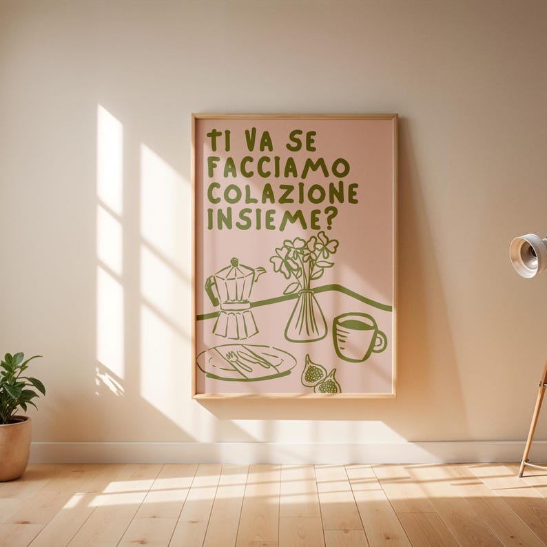 May include: A pink and green illustrated poster with the text "Ti va se facciamo colazione insieme?" which translates to "Do you want to have breakfast together?" The poster features a coffee pot, a vase of flowers, a cup of coffee, and figs.
