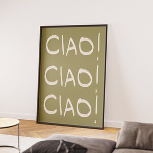 May include: A framed print with a green background and the word "CIAO!" repeated three times in white text.