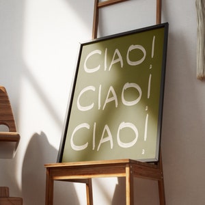 May include: A framed print with a green background and white text that says "CIAO!" three times.