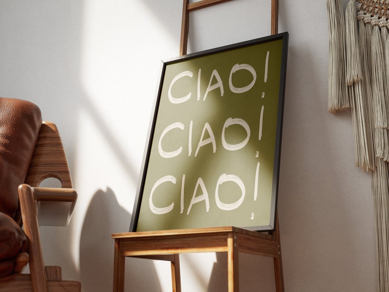 May include: A framed print with a green background and white text that says "CIAO!" three times.