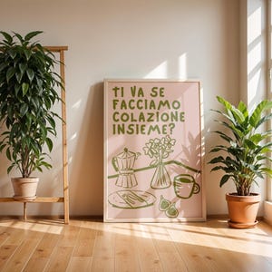 May include: A pink and green illustrated poster with the text "Ti va se facciamo colazione insieme?"  The poster depicts a coffee pot, a plate with cutlery, a vase of flowers, and a cup of coffee.