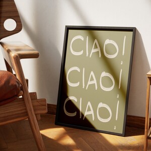 May include: A framed print with the word "CIAO" repeated three times in a white, brushstroke font on a green background.