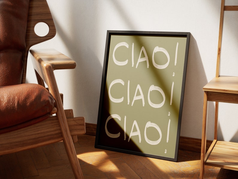 May include: A framed print with the word "CIAO" repeated three times in a white, brushstroke font on a green background.