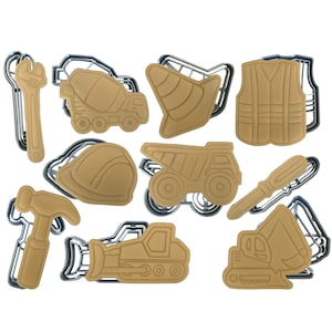 May include: A set of 10 brown construction-themed cookie cutters. The cutters include a cement mixer, a dump truck, a bulldozer, a backhoe, a hard hat, a traffic cone, a wrench, a screwdriver, a safety vest, and a hammer.