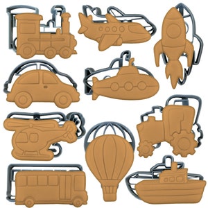 May include: A set of 10 cookie cutters shaped like different vehicles, including a train, aeroplane, rocket, car, submarine, helicopter, hot air balloon, tractor, bus, and boat. The cutters are made of metal and have a silver finish.